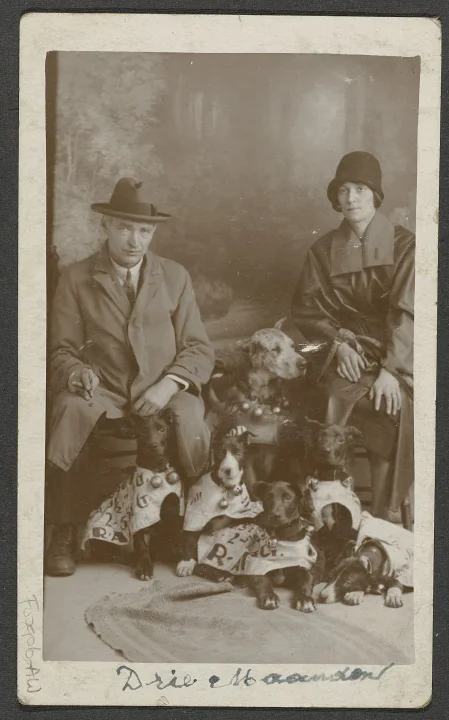 Two people and several dogs in a framed monochrome photograph · Dog photo — Pictures of Dog